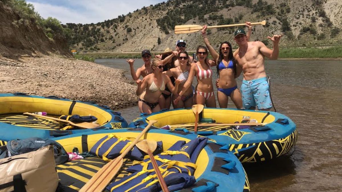 a group of people riding on the back of a boat