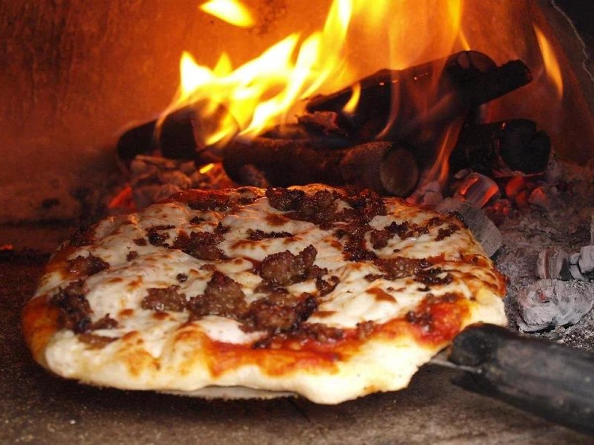 a pizza sitting on top of a stove