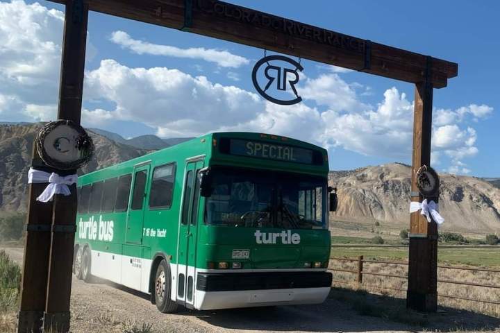 a bus driving down a dirt road
