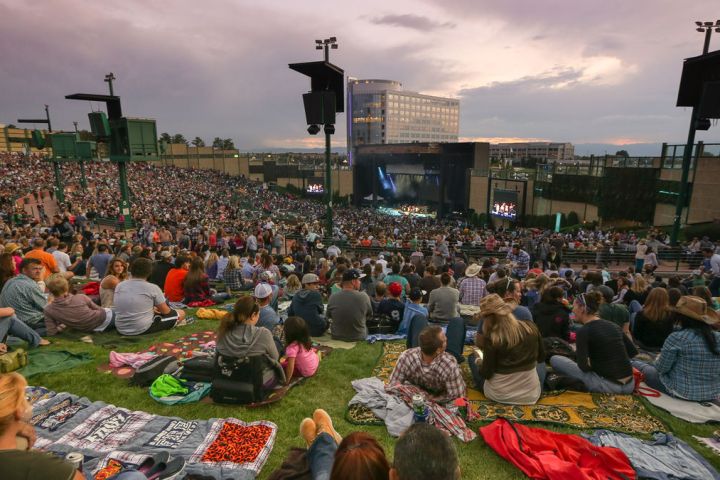 a group of people sitting at a table in front of a crowd